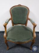 A continental salon armchair in green dralon