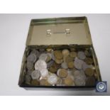 An old money tin containing a quantity of coins, half crowns etc.