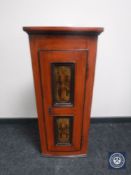 An antique hand painted corner cabinet