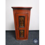 An antique hand painted corner cabinet