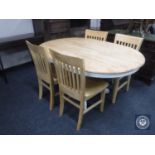 An oval pine kitchen table together with four chairs