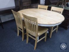 An oval pine kitchen table together with four chairs