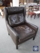 A mid 20th century brown leather high back armchair
