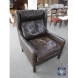 A mid 20th century brown leather high back armchair