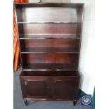 A set of mahogany open bookshelves fitted cupboard beneath