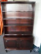 A set of mahogany open bookshelves fitted cupboard beneath