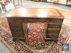 A Georgian style mahogany pedestal desk with brown tooled leather top,