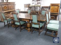 An early 20th century oak pull out dining table and eight high back carved oak chairs (one damaged)