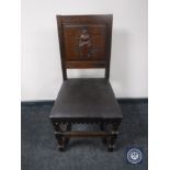 A carved oak panel back dining chair