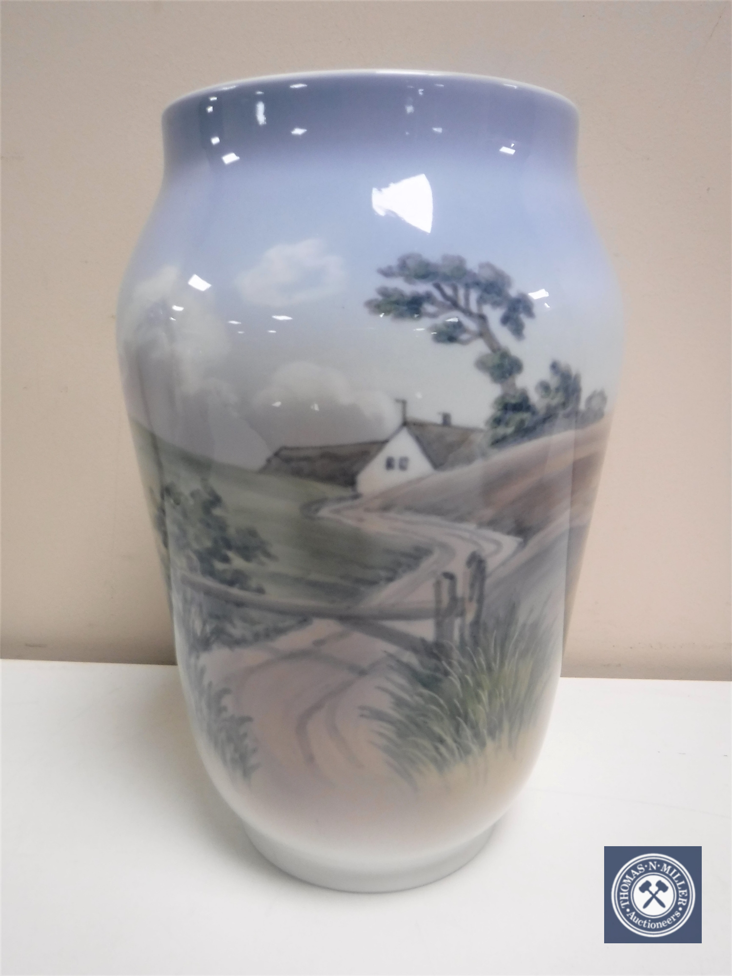 A Royal Copenhagen vase depicting a rural landscape, height 25.