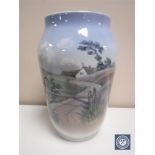 A Royal Copenhagen vase depicting a rural landscape, height 25.