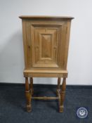 A blond oak cabinet on stand