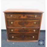 A late nineteenth century continental mahogany four drawer chest with brass handles