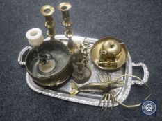 A tray of brass candlesticks, miners ornament, brass bell etc.