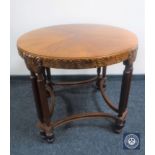 A circular carved mahogany occasional table