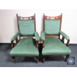 A pair of Edwardian oak Arts & Crafts armchairs upholstered in green fabric