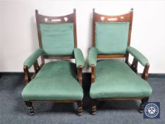 A pair of Edwardian oak Arts & Crafts armchairs upholstered in green fabric