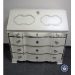 An antique hand painted cream and gilt serpentine fronted bureau