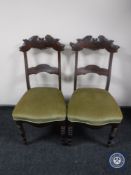 A pair of antique mahogany dining chairs on turned legs