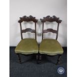 A pair of antique mahogany dining chairs on turned legs