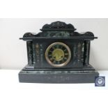 A Victorian slate mantel clock with painted brass dial