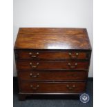 A George III mahogany bureau on bracket feet