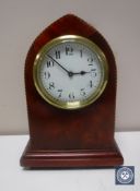 An inlaid mahogany mantel clock with key