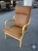 A beech framed brown leather armchair