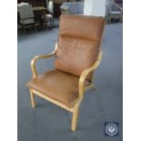 A beech framed brown leather armchair