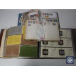 A box containing American first day covers, stamps,