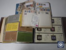 A box containing American first day covers, stamps,