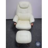 A swivel relaxer chair and stool in cream leather