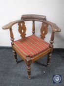 A carved oak corner chair