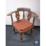 A carved oak corner chair