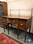 A Regency inlaid mahogany serving table/sideboard with brass rail back,