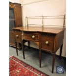 A Regency inlaid mahogany serving table/sideboard with brass rail back,