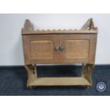 An Edwardian oak double door wall cabinet with shelf