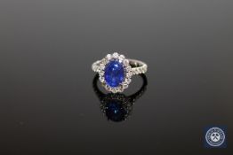 An 18ct white tanzanite and diamond cluster ring, the oval-cut,