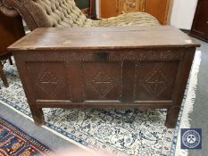 An early 19th century panelled oak coffer,