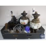 A box of converted oil lamps, spelter figural lamp, Russian dolls, assorted glass ware,
