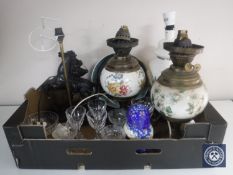 A box of converted oil lamps, spelter figural lamp, Russian dolls, assorted glass ware,