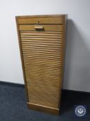 An oak shutter fronted musical cabinet (locked)
