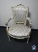A twentieth century cream and gilt armchair upholstered in Regency style striped fabric