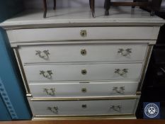 A continental oak painted five drawer chest with brass handles