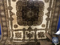 A machine made eastern style carpet on brown ground