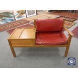 A mid twentieth century oak storage telephone table upholstered in red leather