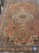 A fringed woollen Persian carpet