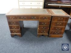 A mahogany twin pedestal writing desk fitted with nine drawers and green tooled leather inset panel