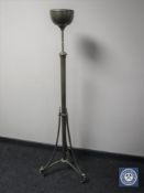 An antique brass rise and fall standard lamp base