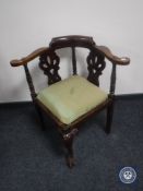 An antique corner chair on claw and ball feet